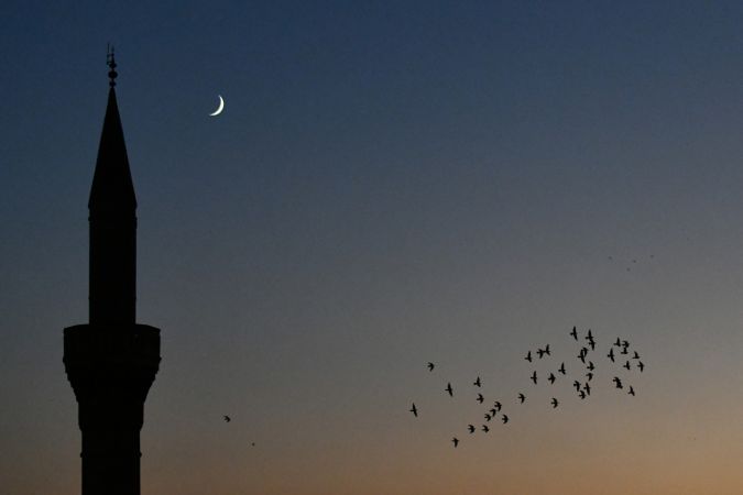 Gaziantep'te  gün batımından hemen sonra görünen hilal, cami minaresi ve kuşlarla güzel görüntü oluşturdu. 2